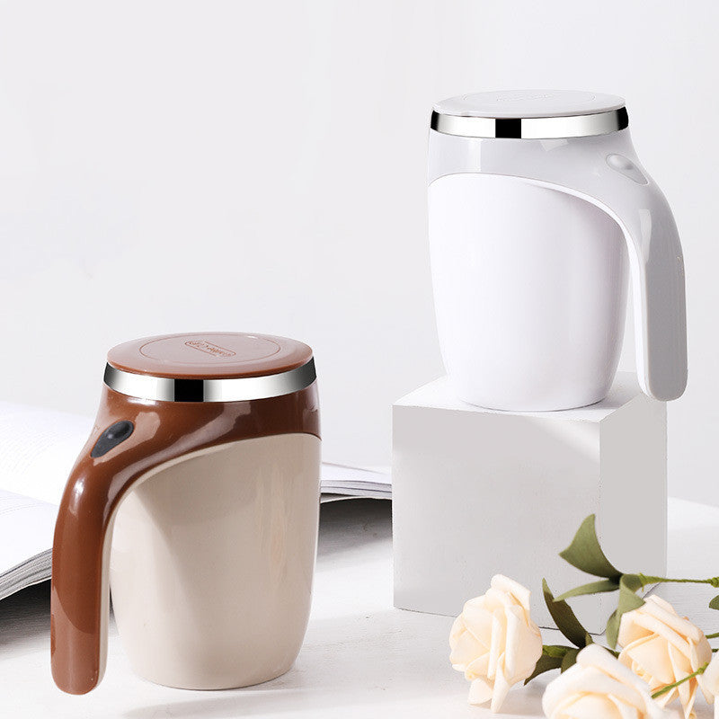 Two ceramic mugs with handles on a white surface, one brown and one white, with a small bouquet of flowers.